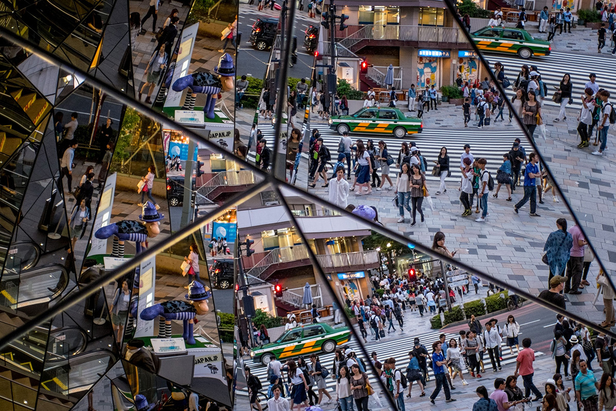 Photo: People are reflected in a shopping mall mirror at a busy intersection in the shopping district of Harajuku in Tokyo on June 18, 2015. (Photo by Chris McGrath/Getty Images)