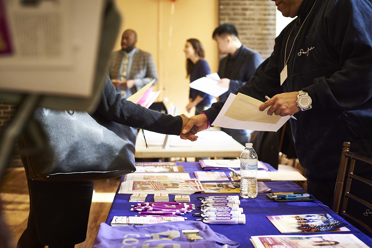 Photo: A job seeker shakes hands with a company representative during a career fair in the Brooklyn borough of New York.