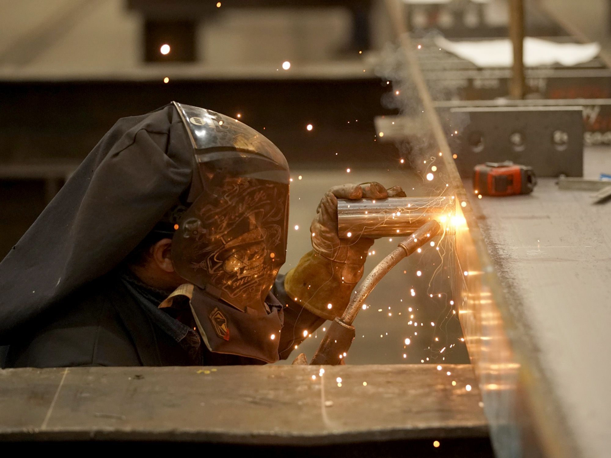 Photo: A worker welds a structural steel beam during production at a facility in West Jordan, Utah. Photographer: George Frey/Bloomberg.