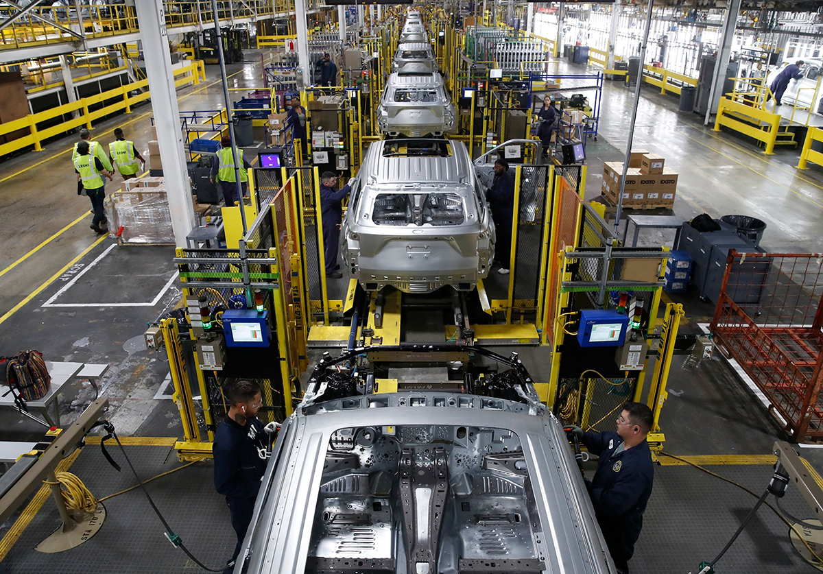 Photo: Workers assemble cars at Ford's Assembly Plant in Chicago. Photographer: Jim Young/AFP/Getty Images