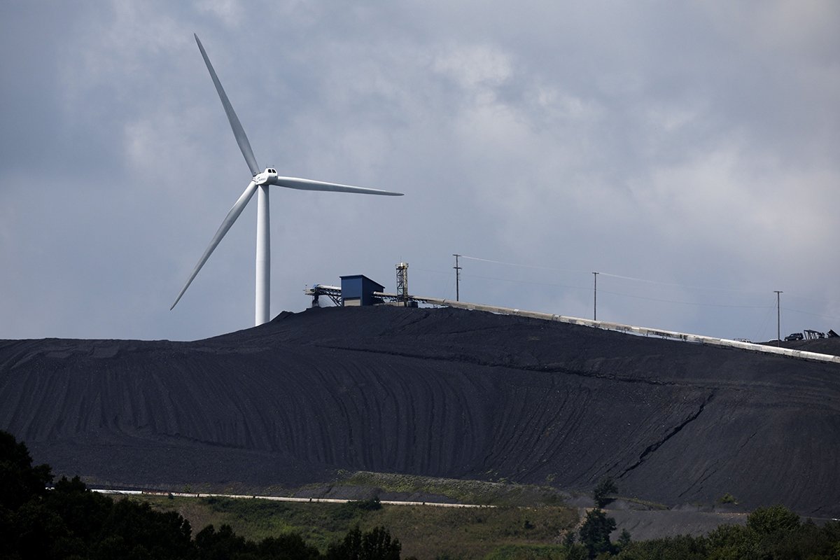 Photo: A turbine from the Roth Rock wind farm spins on the spine of Backbone Mountain behind the Mettiki Coal processing plant on August 23, 2022 in Oakland, Maryland. (Photo by Chip Somodevilla/Getty Images)
