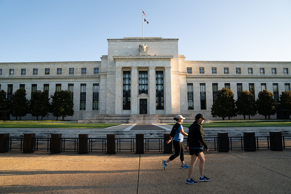 Photo: Joggers pass the Marriner S. Eccles Federal Reserve building in Washington, D.C.