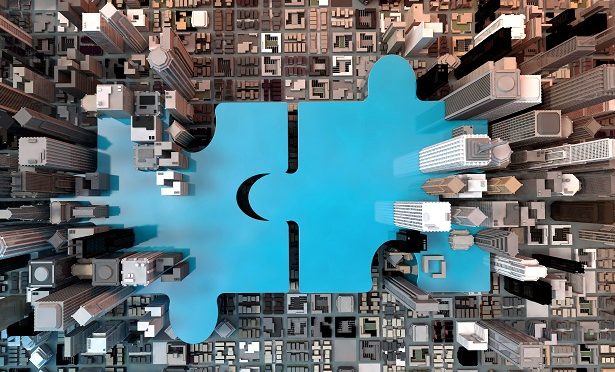 Stock illustration: Puzzle pieces over background of aerial view of skyscrapers. (Credit: Shutterstock)