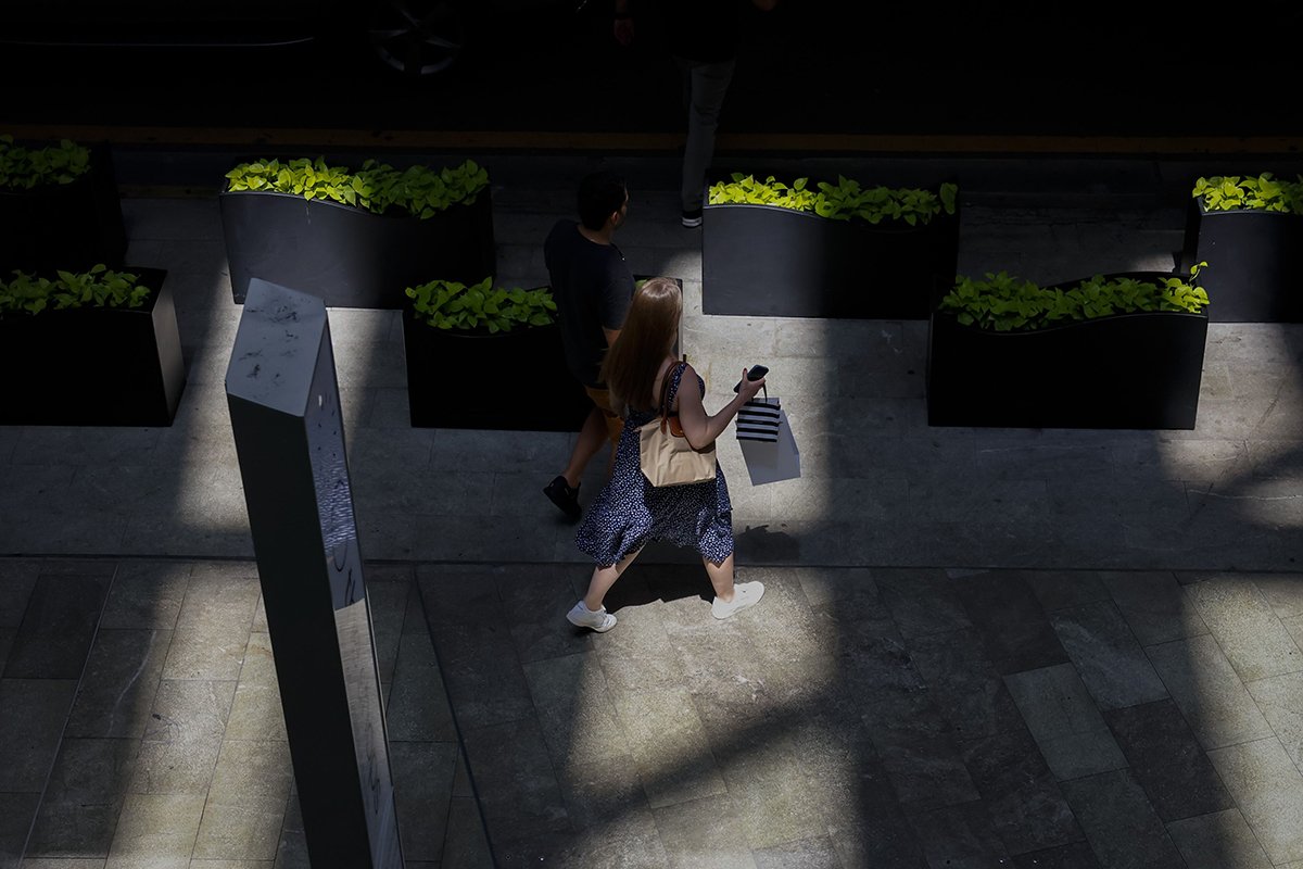 Stock photo: Consumers walking through a shopping area.