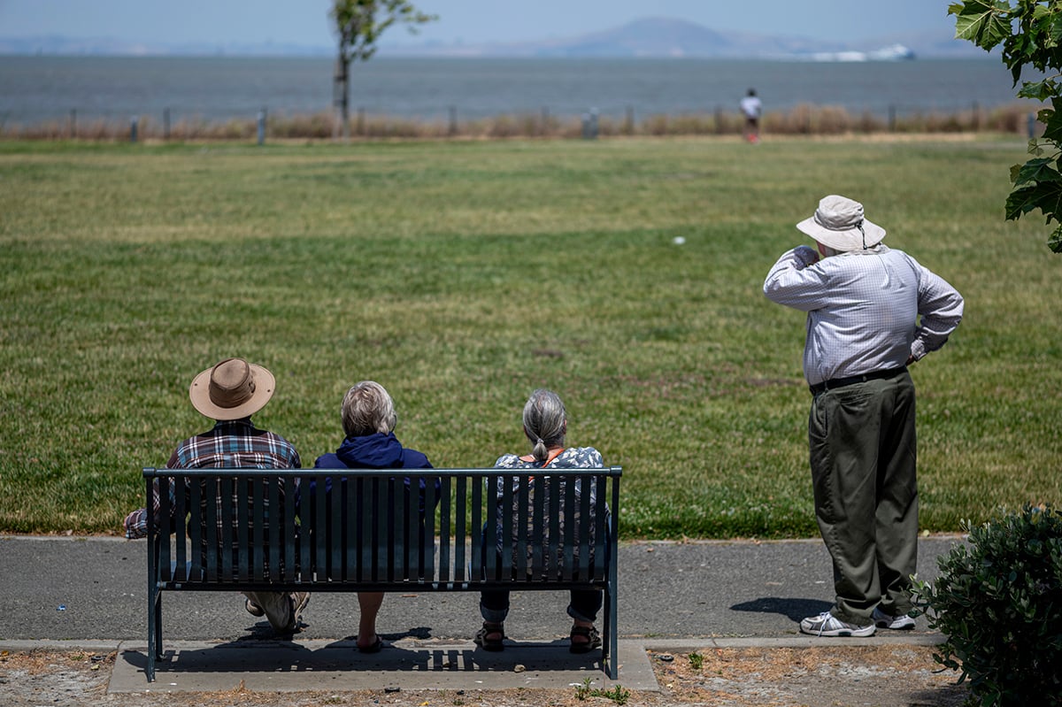 People sit on a bench in Hercules, California, on June 20, 2024. Photographer: David Paul Morris/Bloomberg.