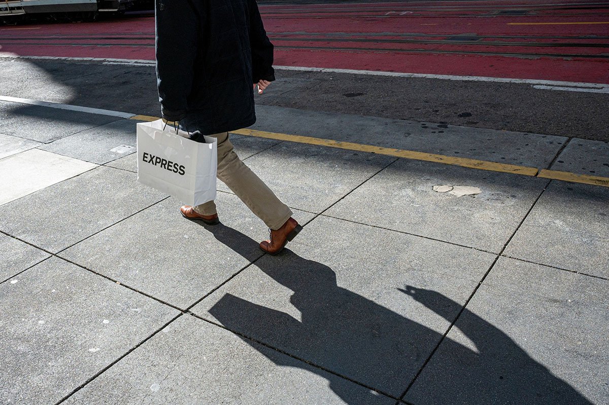 Photo: A shopper carries an Express bag on Powell Street in San Francisco on November 29, 2022. 