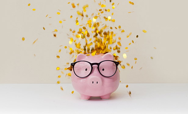 Stock image: piggy bank with money flowing