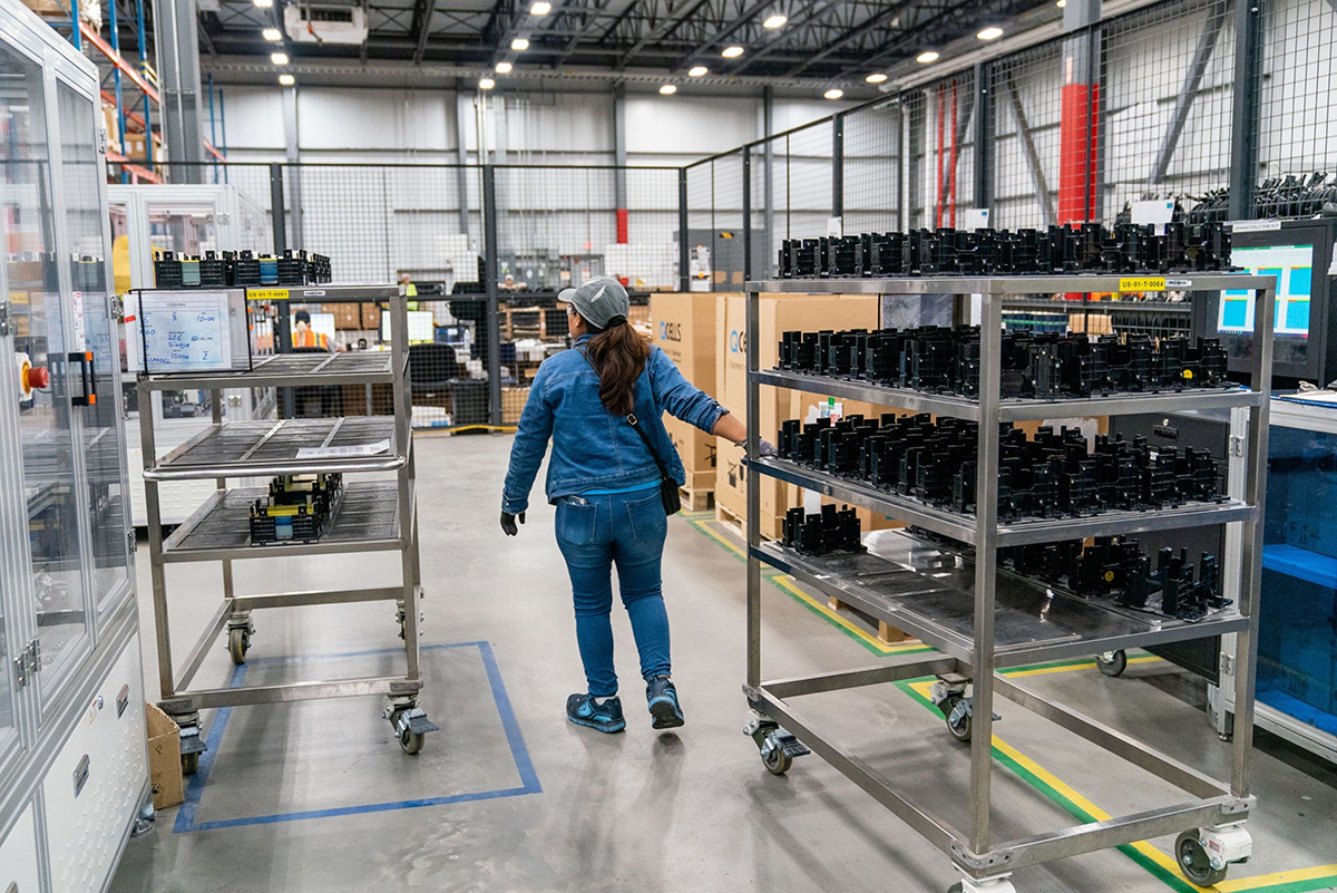 Photo: A worker moves a cart with finished solar cells at the Hanwha Q Cells manufacturing facility in Dalton, Georgia, on October 6, 2022. 