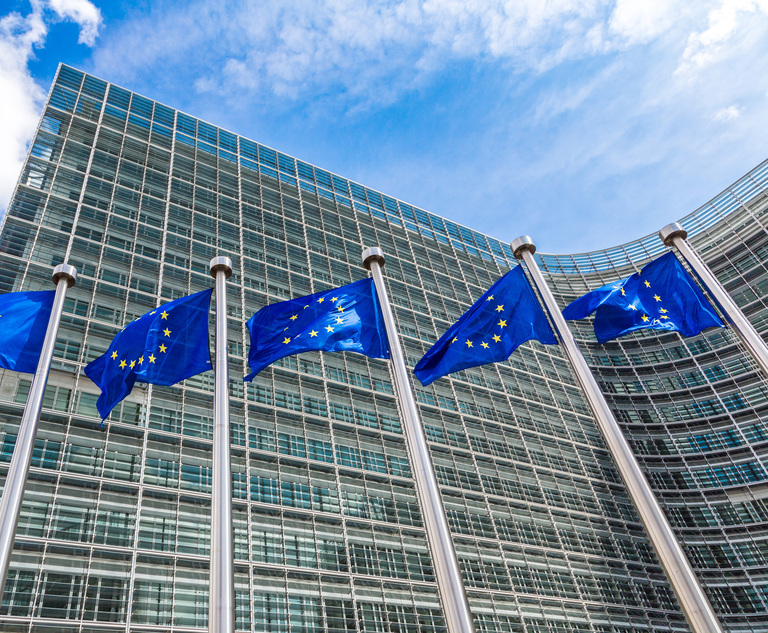 Photo: European flags in front of the headquarters of the European Commission in Brussels.  Photo credit: Figurniy Sergey/Adobe Stock.