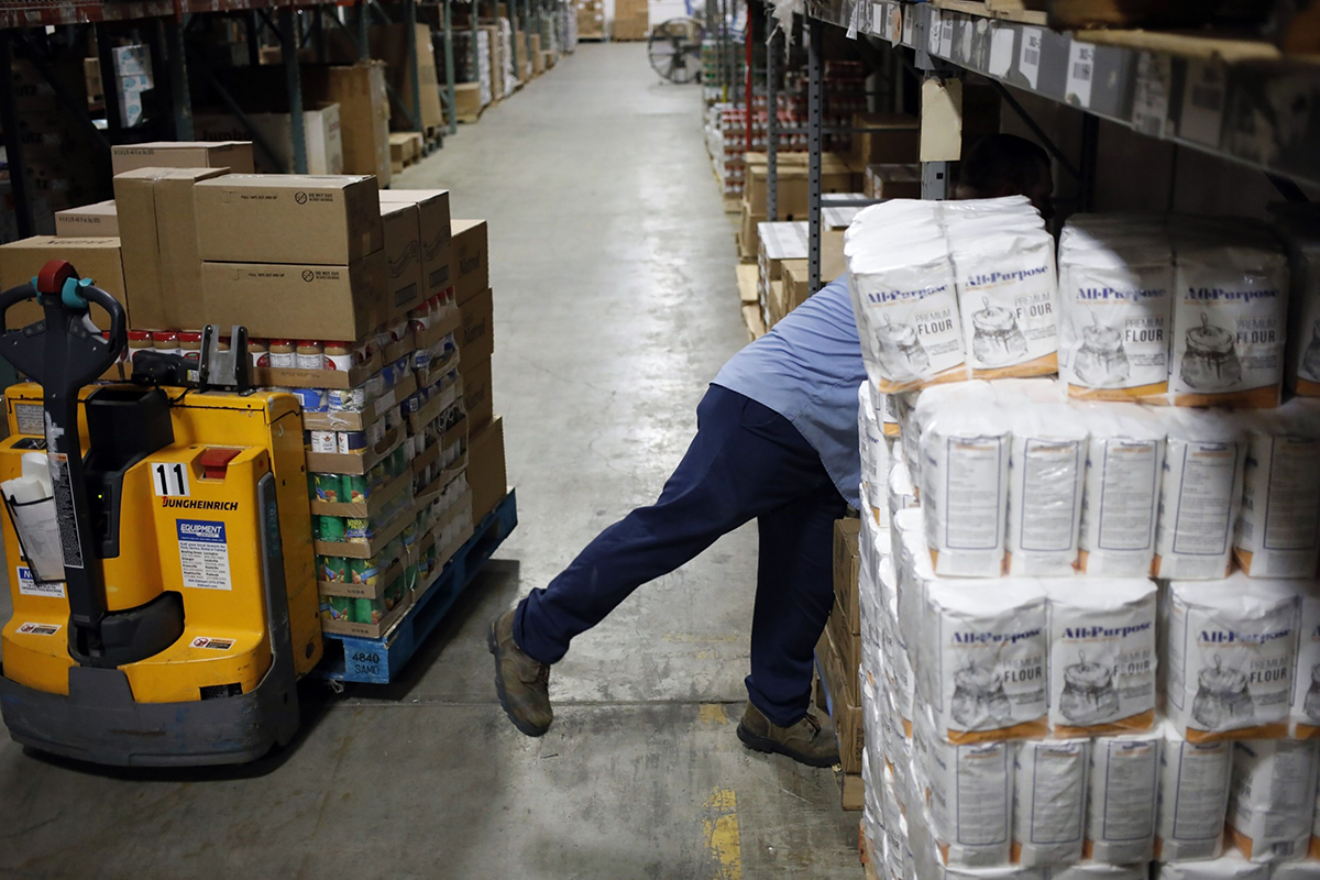 Photo: A worker pulls boxes of donated food from warehouse shelves at the Dare to Care Food Bank in Louisville, Kentucky, on June 16, 2022. Photographer: Luke Sharrett/Bloomberg