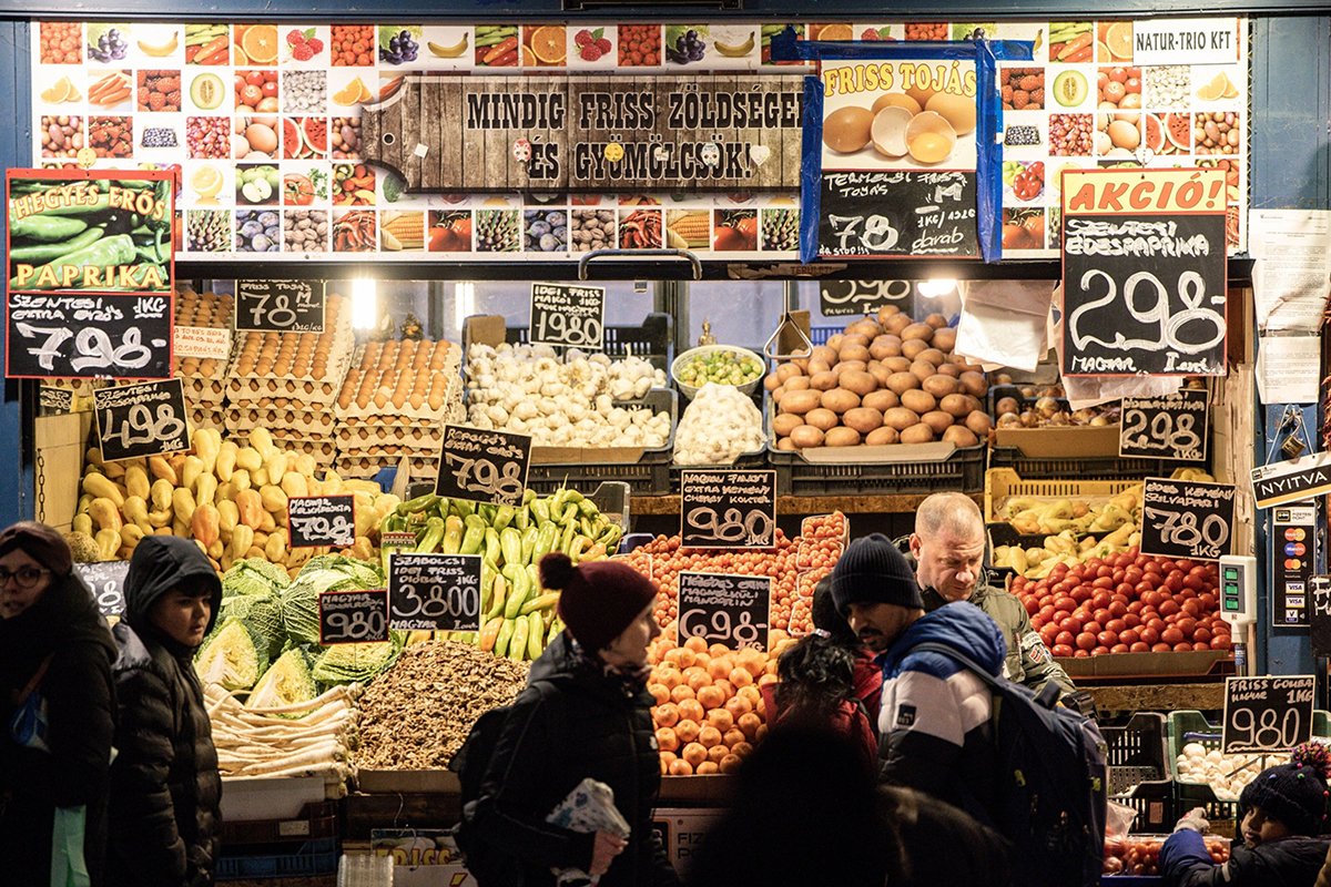 Photo: A vendor serves customers at a fresh produce stall inside the Great Market Hall in Budapest, Hungary, on December 21, 2022.