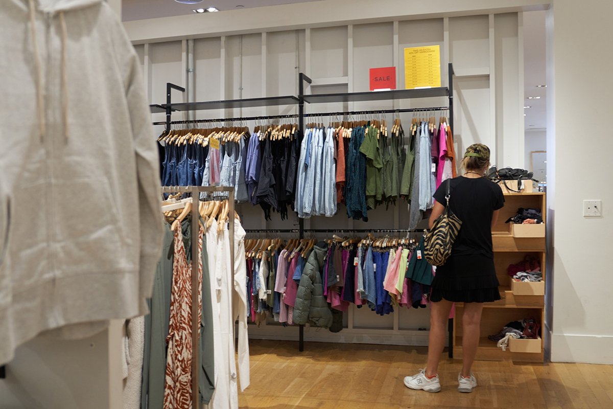 Photo: A woman shops the sale section at a Gap retail store in Los Angeles on September 20, 2022. (Photo by Allison Dinner/Getty Images)