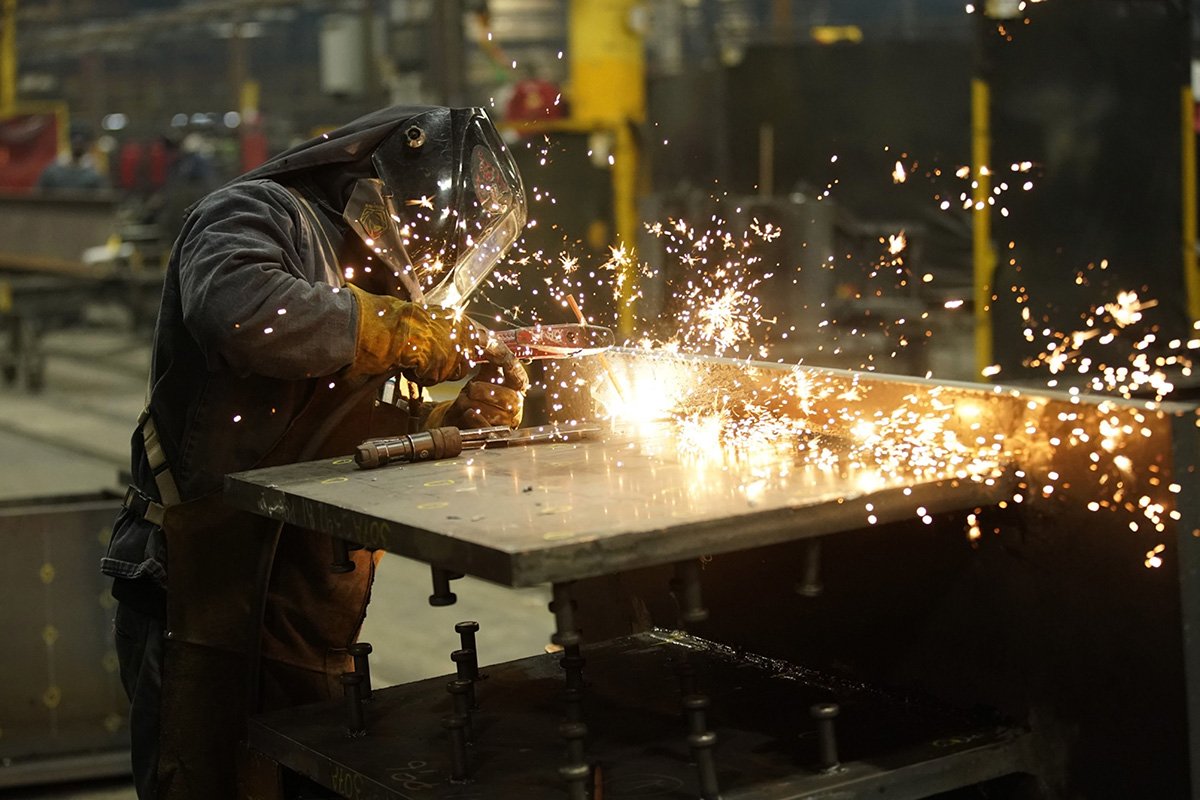 Photo:A worker welds a structural steel beam during production. Photographer: George Frey/Bloomberg