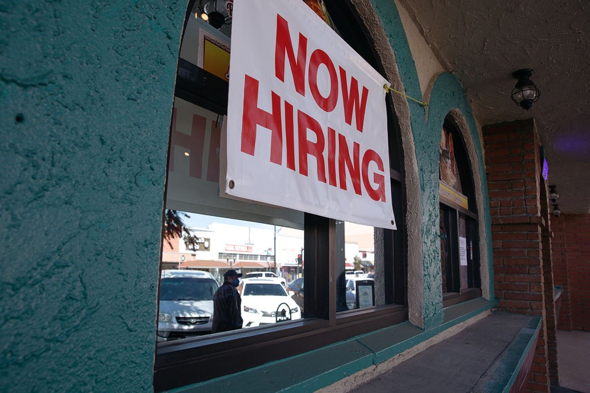 Photo: A "Now Hiring" sign outside a restaurant in Huntington Park, California, on March 24, 2021. Photographer: Jessica Pons/Bloomberg.