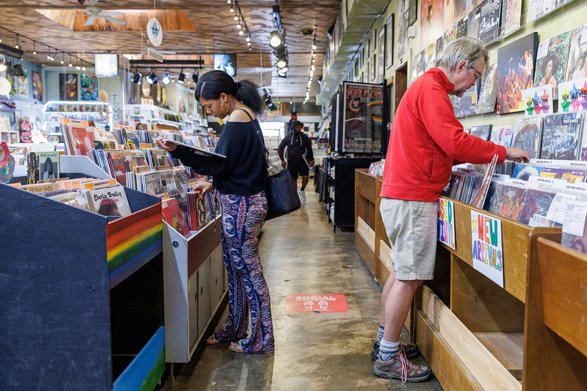 Photo: Shoppers browse albums at a record store in Atlanta, Georgia. Photographer: Dustin Chambers/Bloomberg
