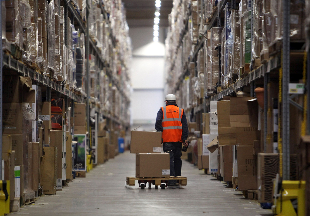 Photo: Staff at the Amazon Swansea, Wales, fulfilment center process orders. (Photo by Matt Cardy/Getty Images)