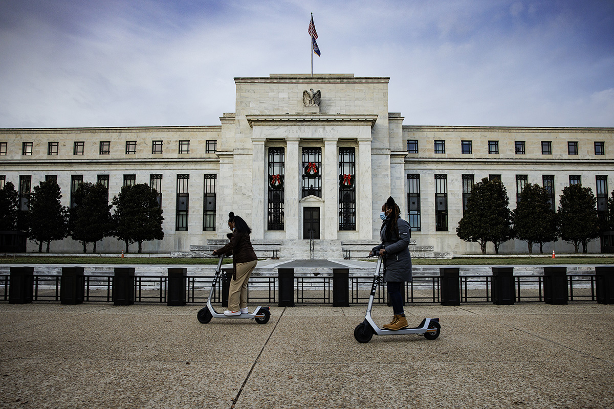Photo: Visitors ride electric scooters near the Marriner S. Eccles Federal Reserve building in Washington, D.C., on November 20, 2021. 