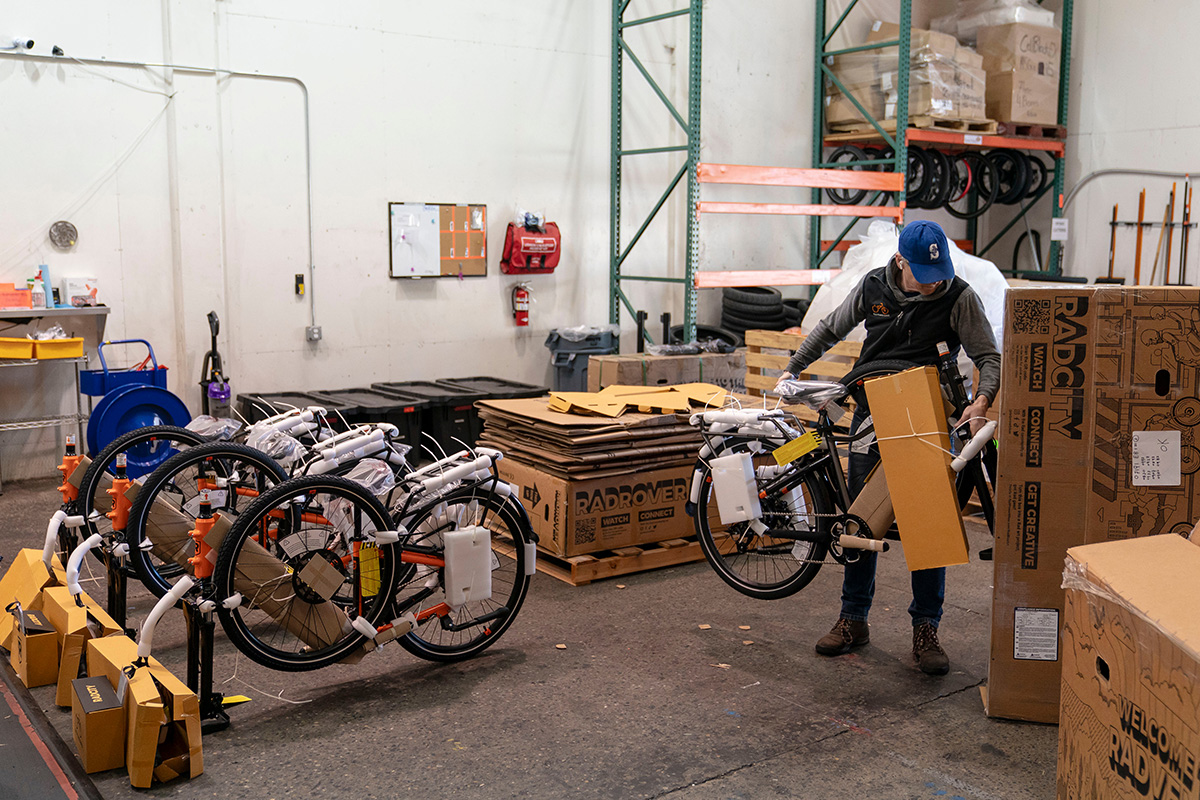 Photo: A worker unpacks boxes of e-bikes at Rad Power Bikes in Seattle, Washington, on April 17, 2024. Photographer: David Ryder/Bloomberg.