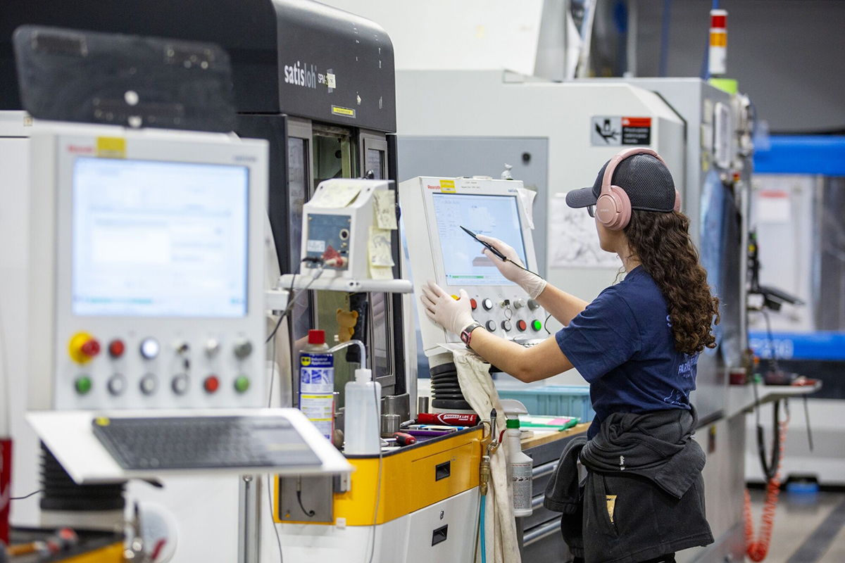 Photo: An employee works on the production floor at a manufacturing facility in Ontario, New York.