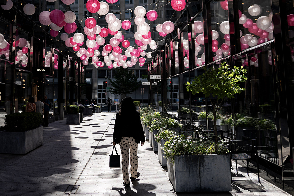 Photo: A pedestrian walks past storefronts at CityCenterDC in Washington, D.C., on May 30, 2024.  Photographer: Bloomberg/Bloomberg.