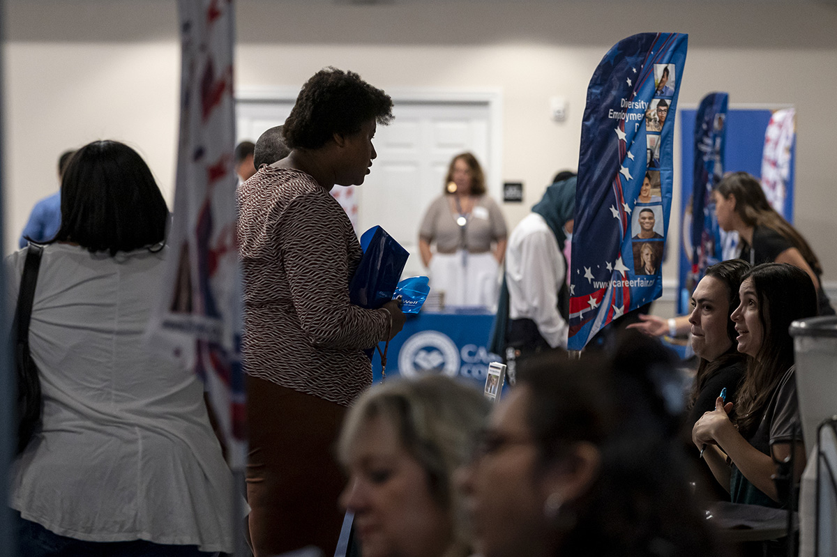 Photo: Attendees and recruiters at a City Career Fair hiring event in Sacramento, California. Photographer: David Paul Morris/Bloomberg.