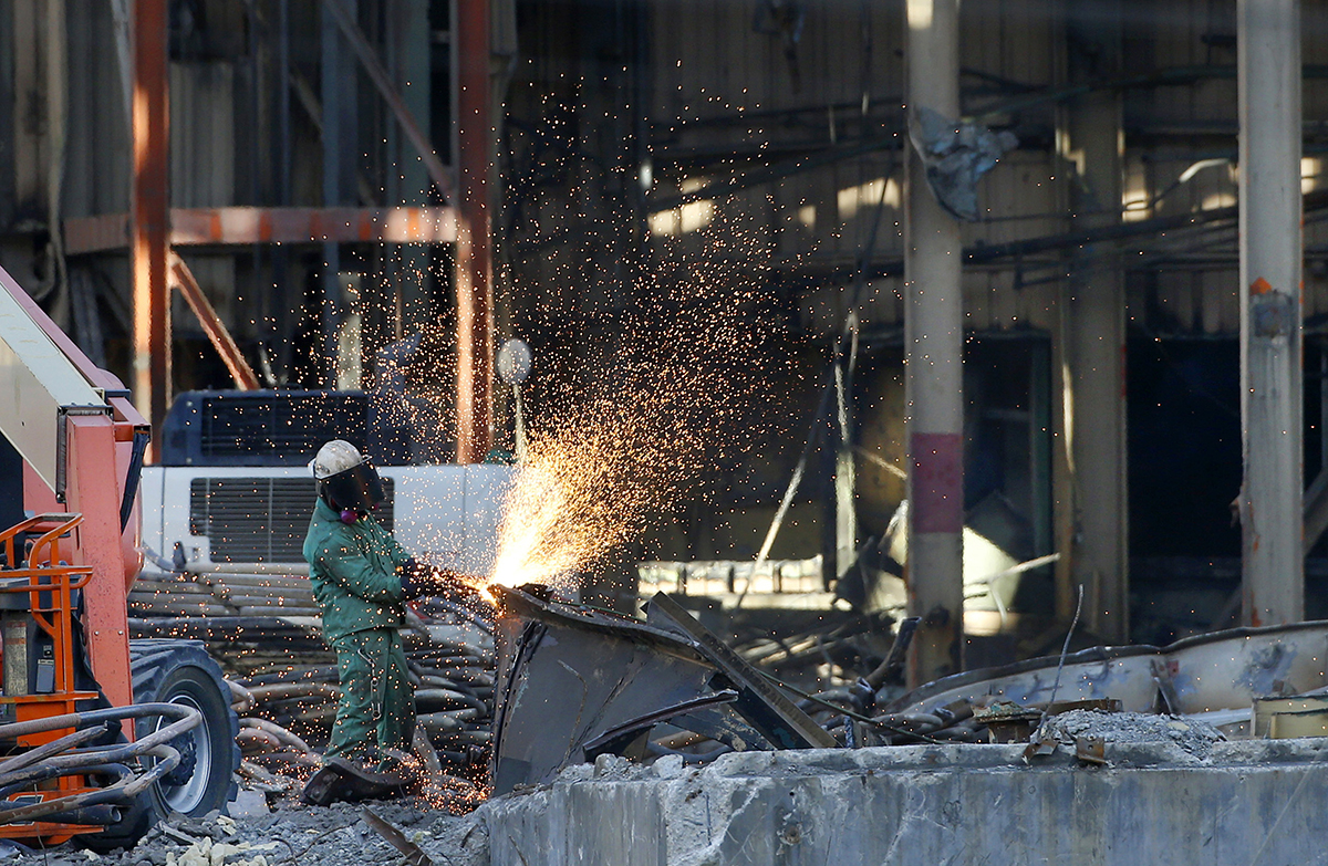 Photo: A worker at a factory. Photographer: George Frey/Bloomberg.