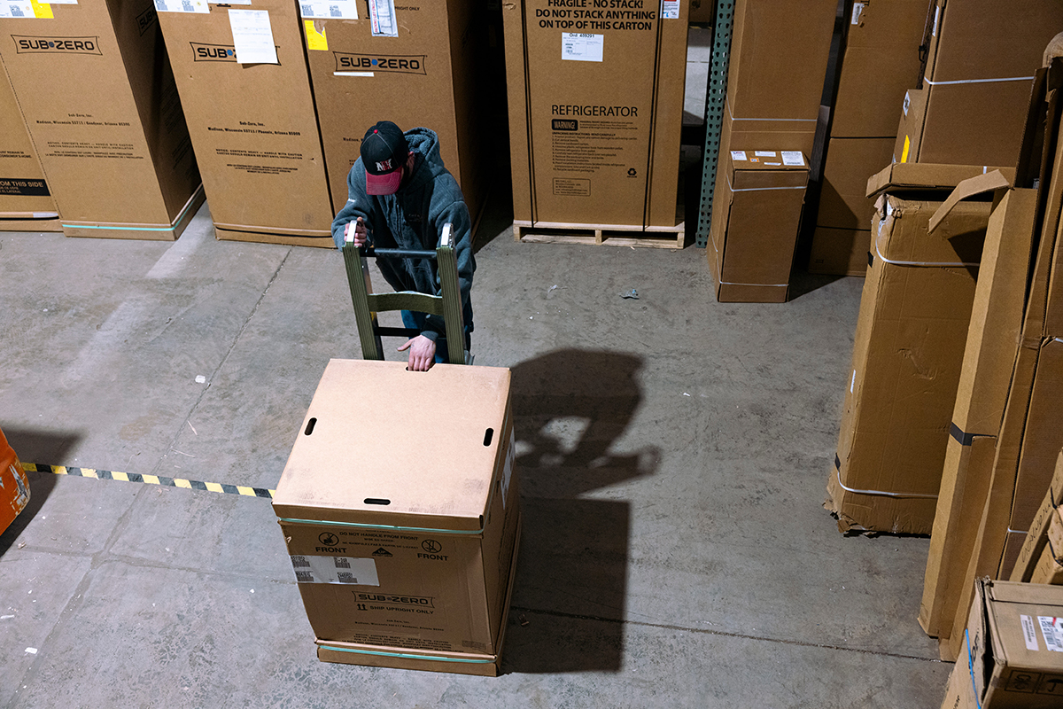 Photo: A worker uses a hand truck to move a Sub Zero refrigerator in a warehouse at Earl B. Feiden Appliance in Latham, New York, on April 18, 2024. Photographer: Angus Mordant/Bloomberg