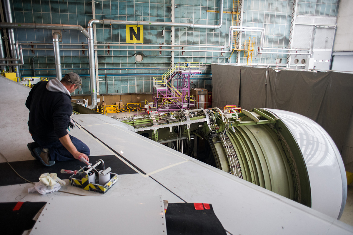 Photo: A worker carries out maintenance on the wing of a Boeing Co. 777-300ER aircraft, operated by Air France-KLM, during its refitting at the Air France Industry hangar at Orly Airport in Paris, France, on September 27, 2022. Photographer: Nathan Laine/Bloomberg.