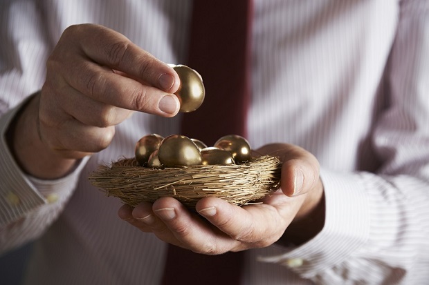 Stock photo: Man holding nest egg of gold. (Photo: Getty)