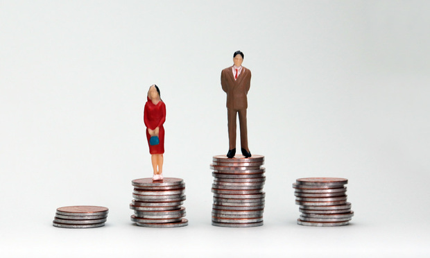 Stock photo: People standing on piles of coins (man's pile is larger than woman's)