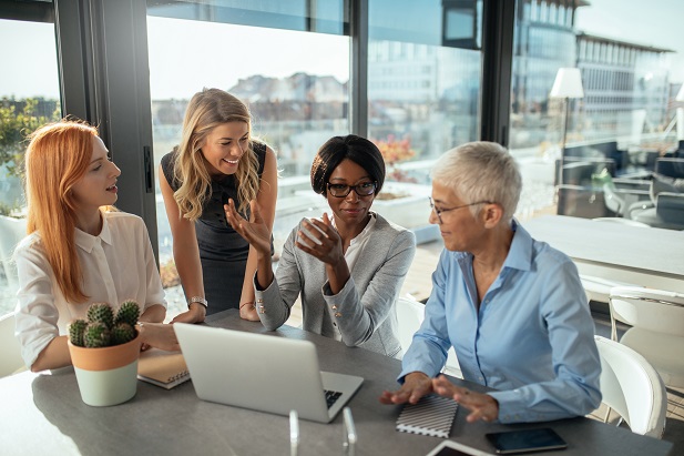 Stock photo: 4 women in office meeting. (Credit: Shutterstock)